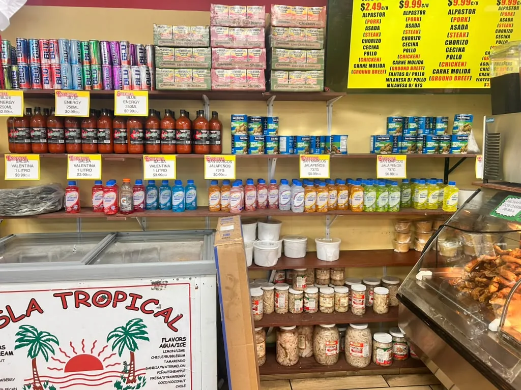 Shelves of salsas next to the taquería hot case